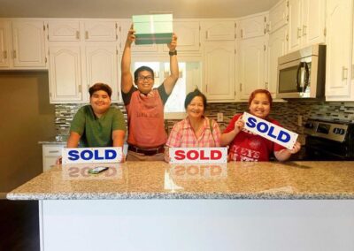 family holding sold signs