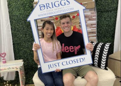 man and woman posing with just closed sign